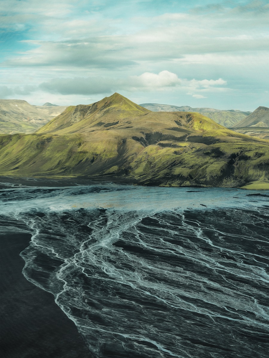 Green mountains overlook braided river delta